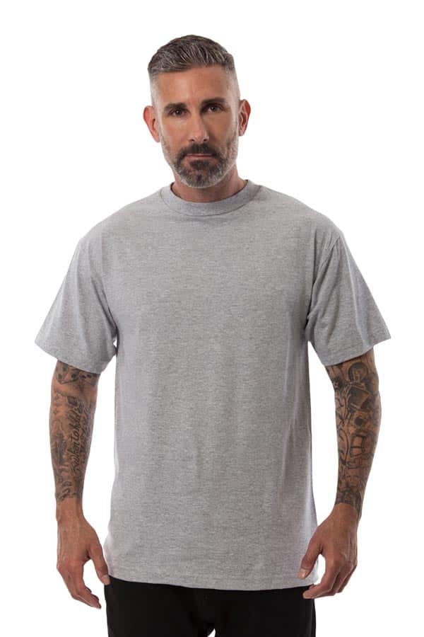 Man with short hair wearing a plain gray T-shirt, showing tattooed arms, white background.