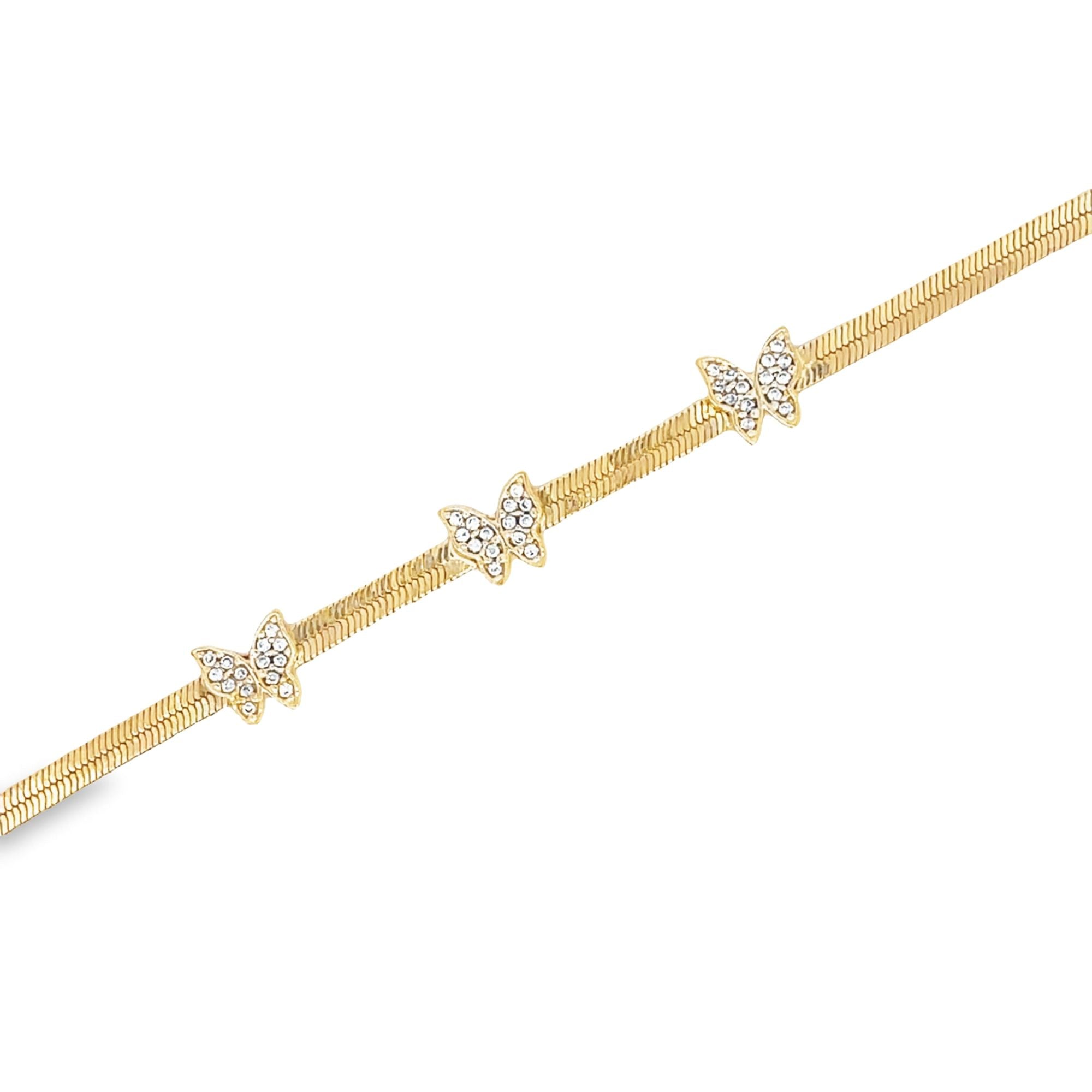 Gold bracelet with three jeweled butterfly charms on a textured band.
