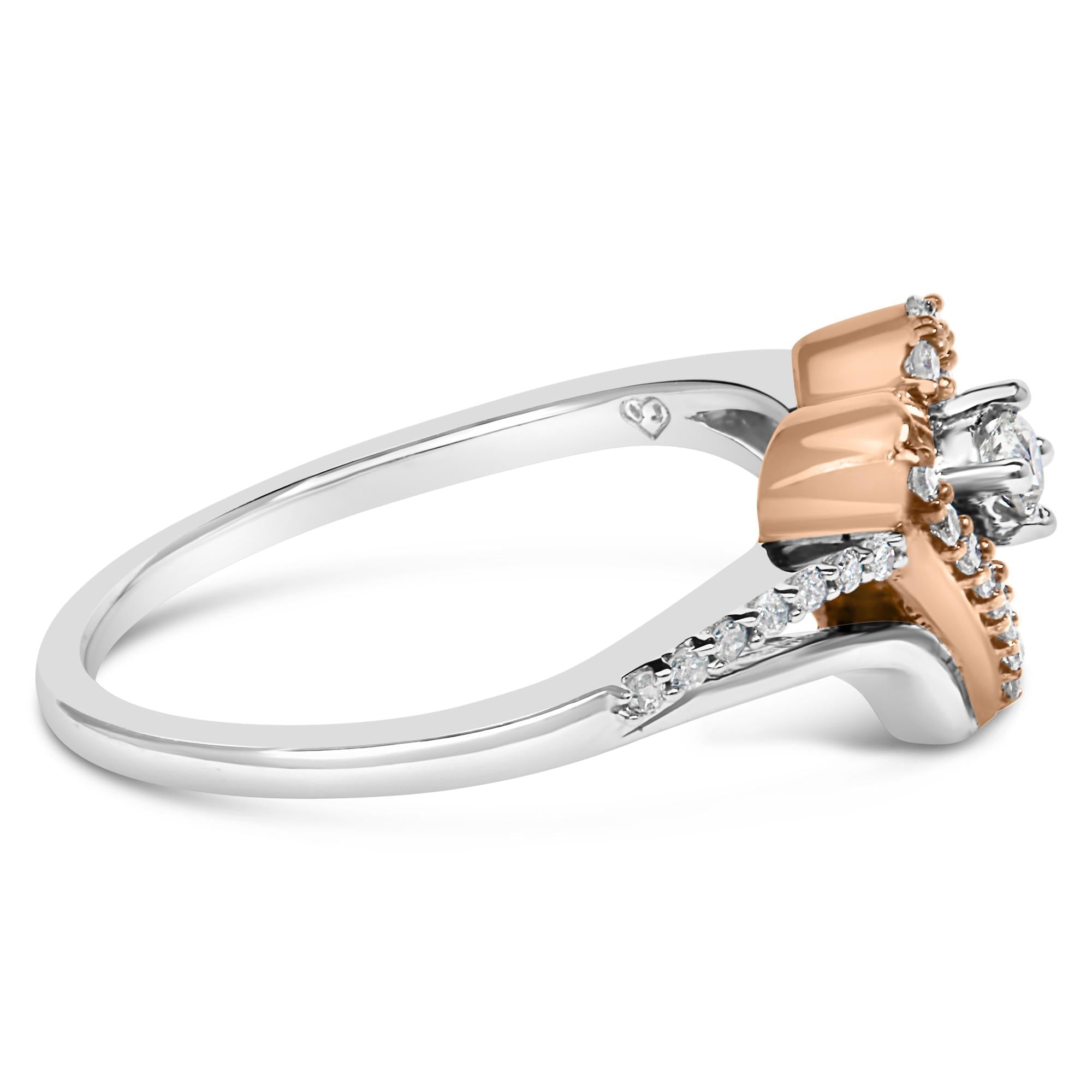 Silver and rose gold ring with a central diamond and small accent diamonds on the band.