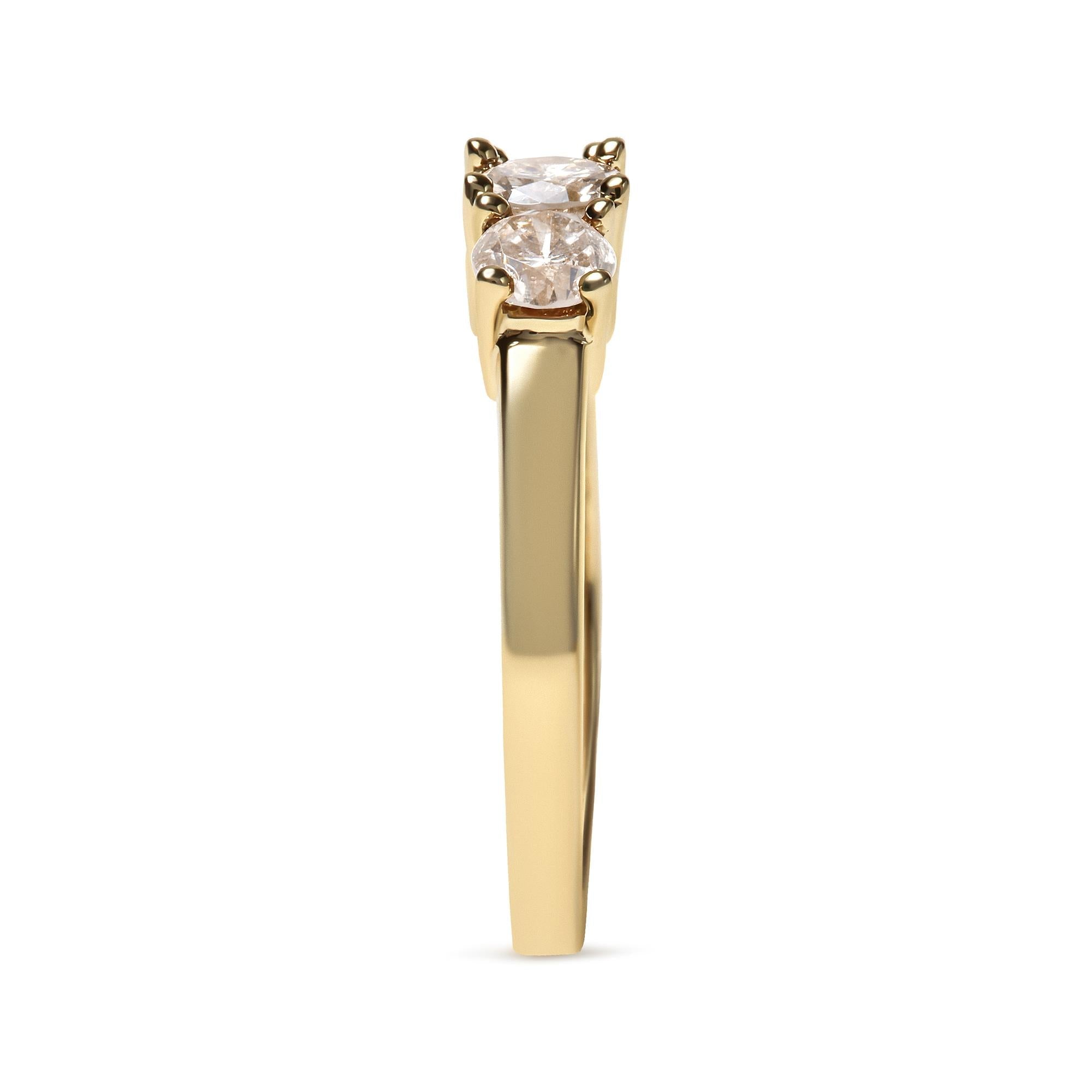 Gold ring with two side-by-side round diamonds, set in a prong setting, viewed from side.