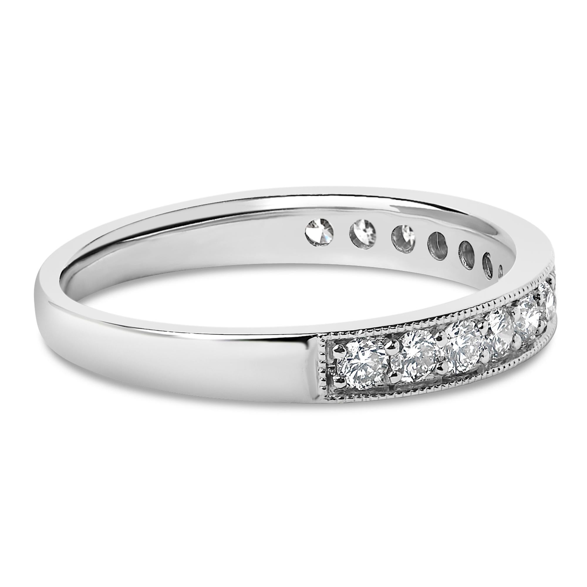 Silver ring with small round diamonds embedded halfway around, polished finish.