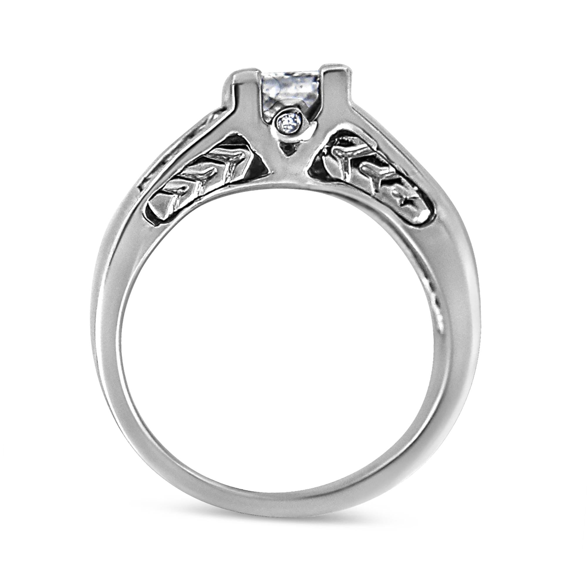 Silver ring with intricate leaf and star patterns on the band, featuring a central diamond.