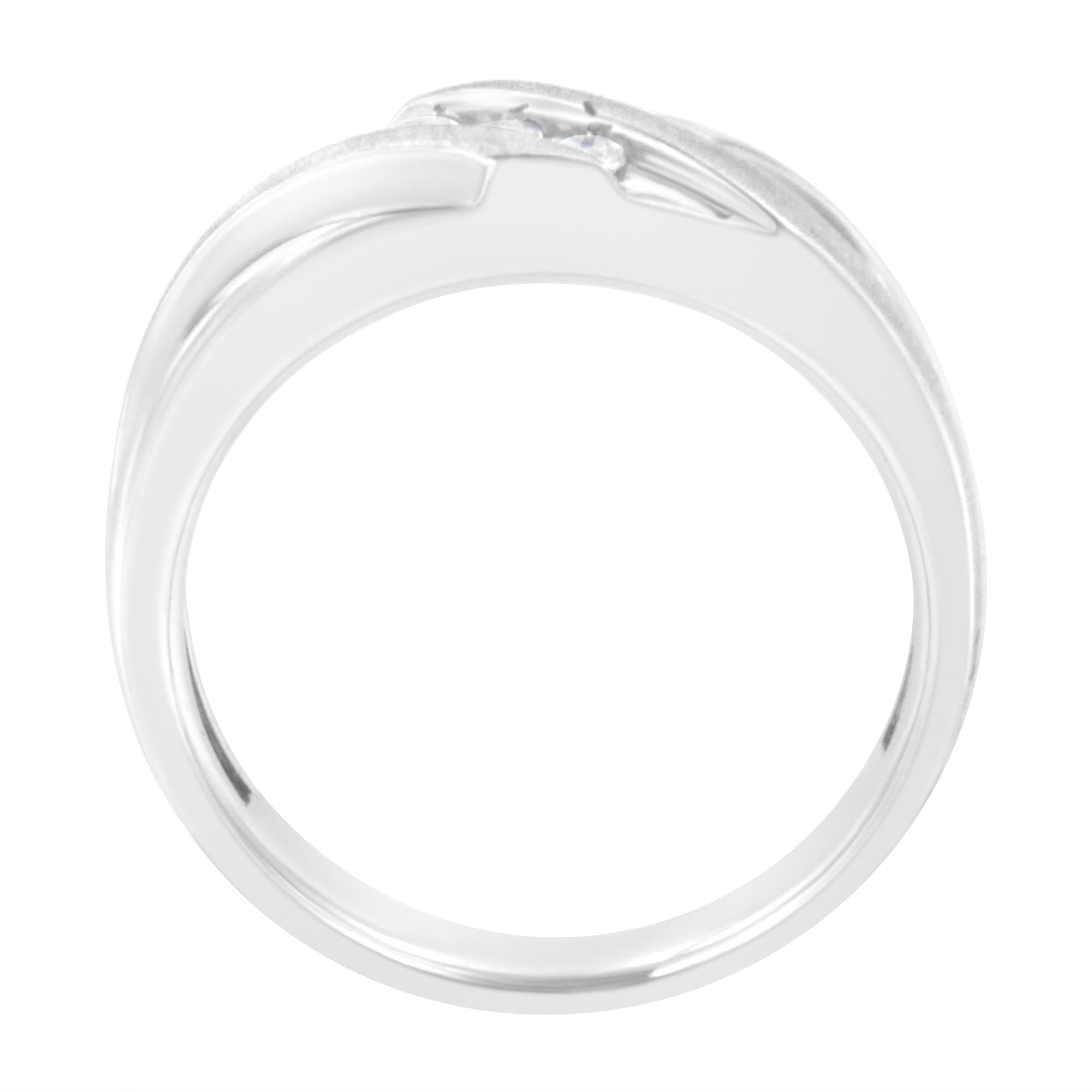 Silver ring, side view, with smooth, polished band and a small diamond setting on top.