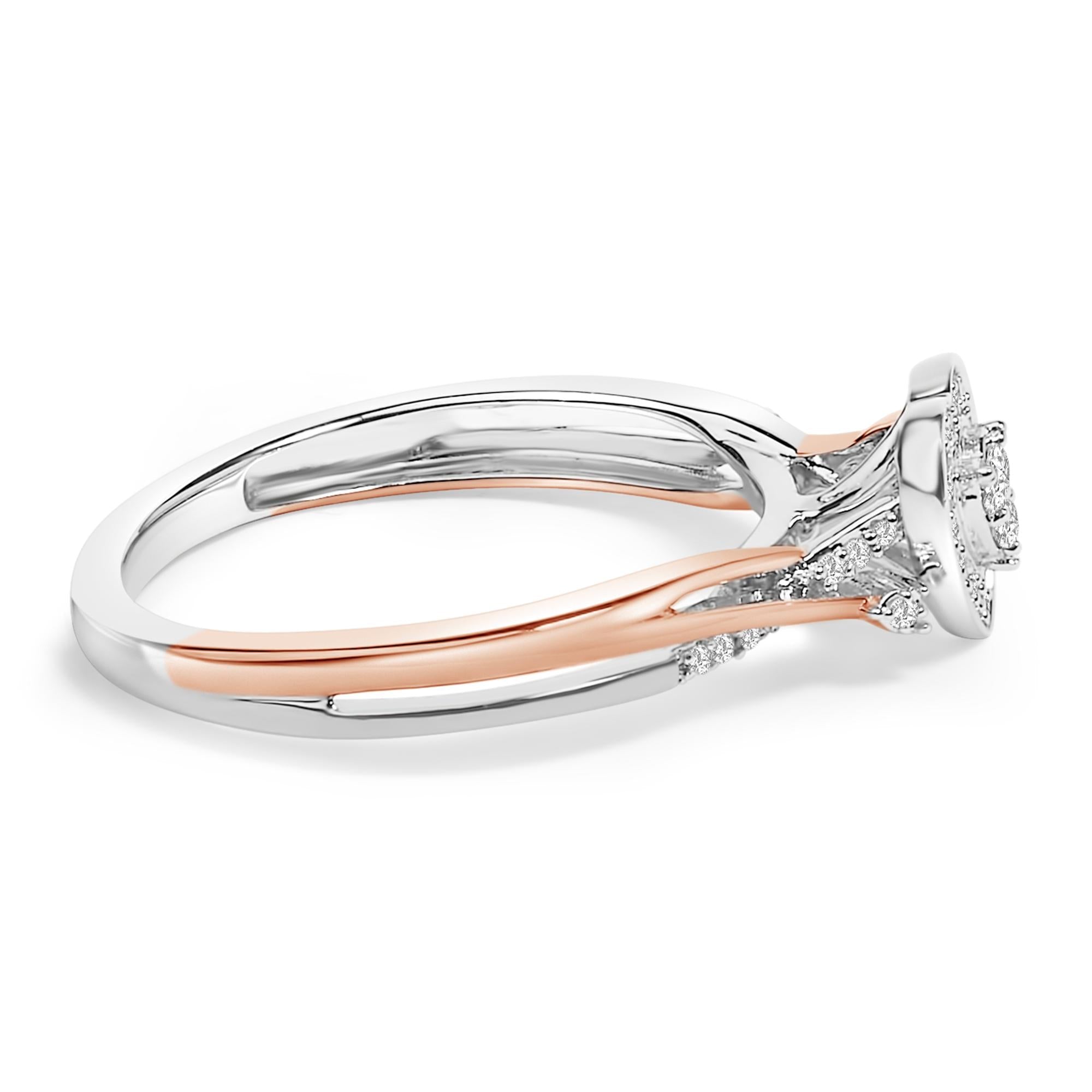 Silver and rose gold ring with a halo of small diamonds around a central stone.