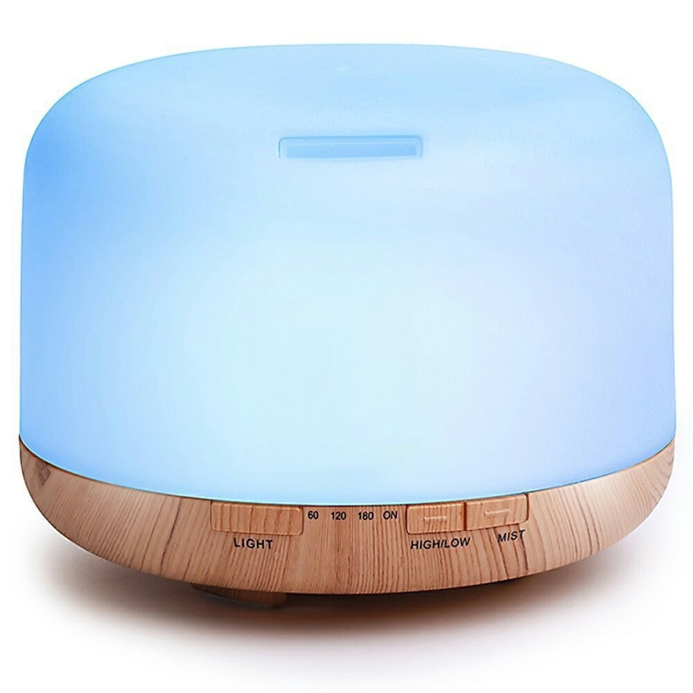 Wooden base diffuser with a glowing blue top, control buttons labeled for light and mist settings.