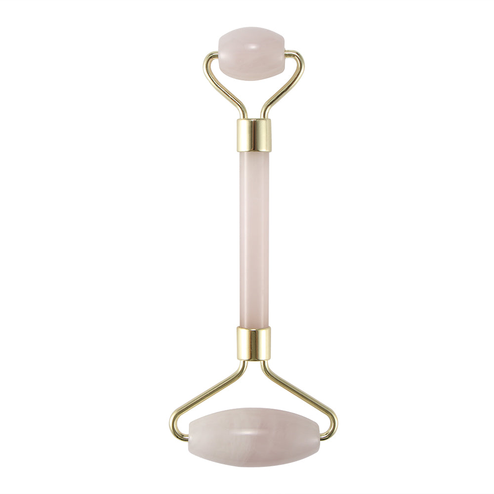 Pink facial roller with gold metal accents, featuring two smooth stone ends.