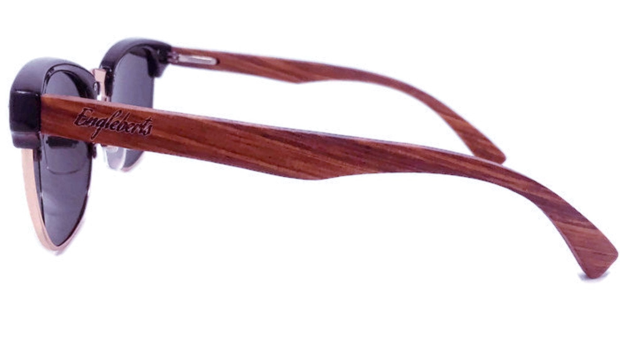 Brown wooden sunglasses with black lenses and engraved text on the arms.
