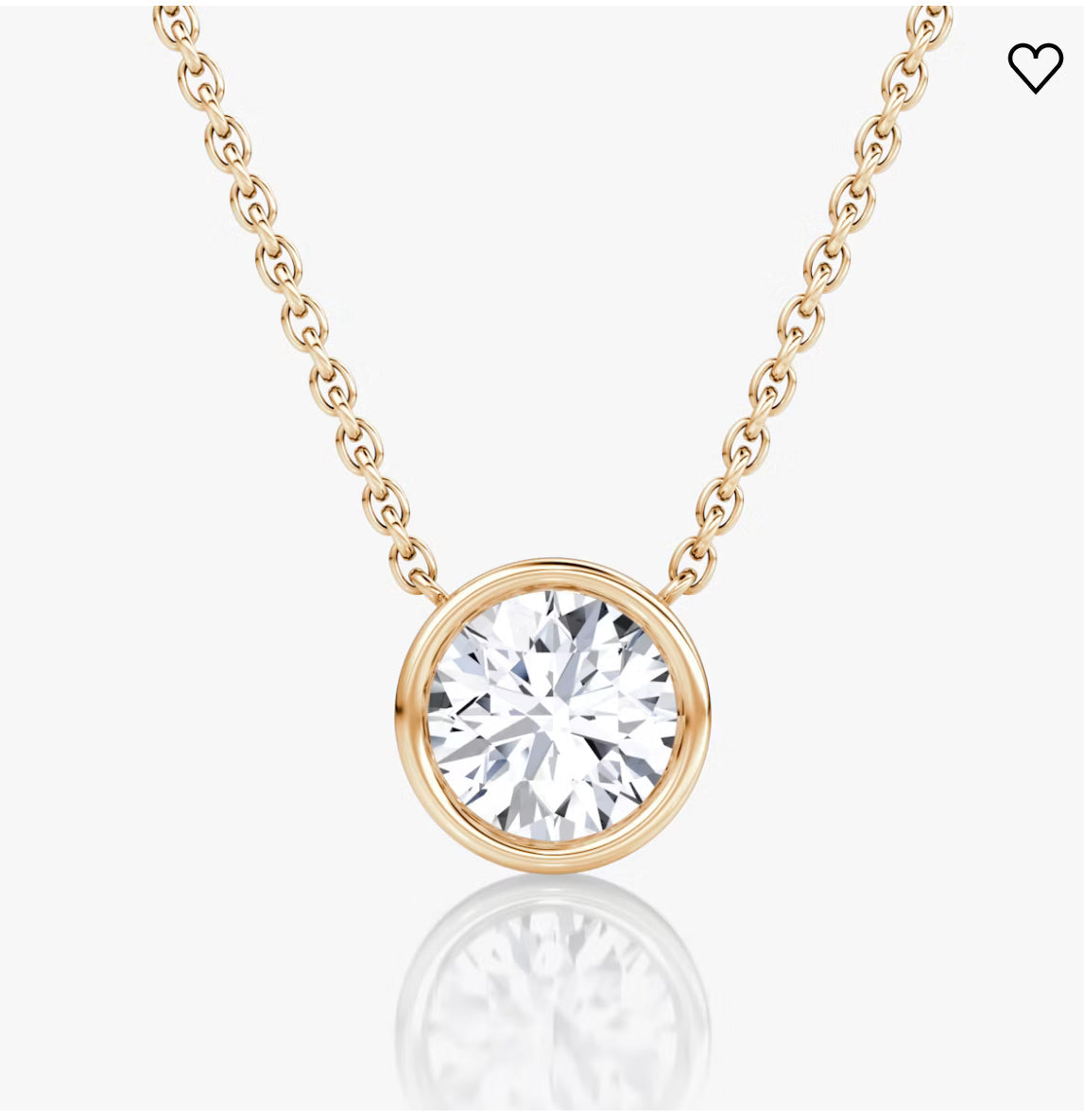 Gold chain necklace with a large round diamond pendant in a sleek bezel setting, on a white background.