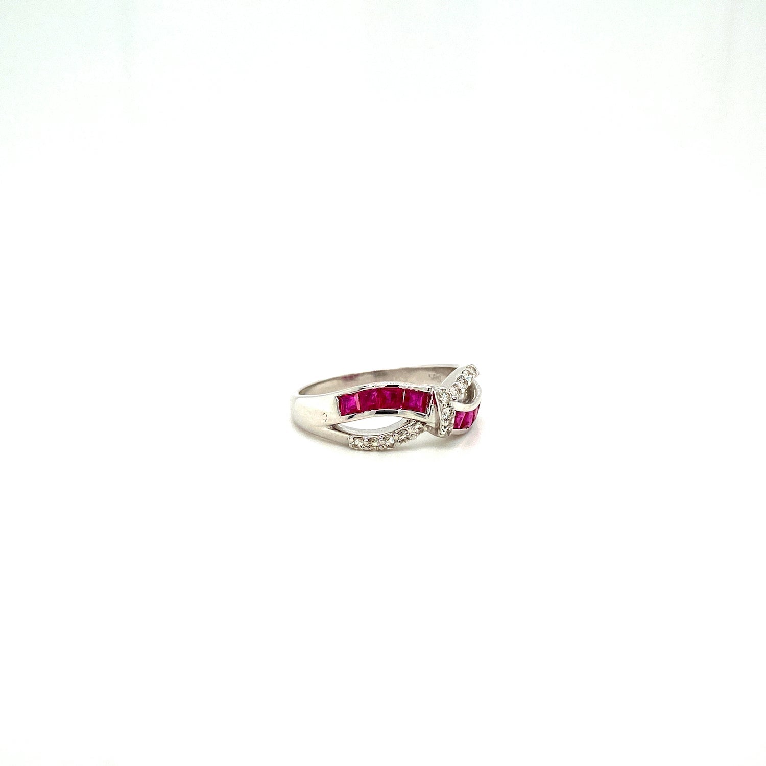 Silver ring with red rectangular stones and small white stones in a twisted design on white background.