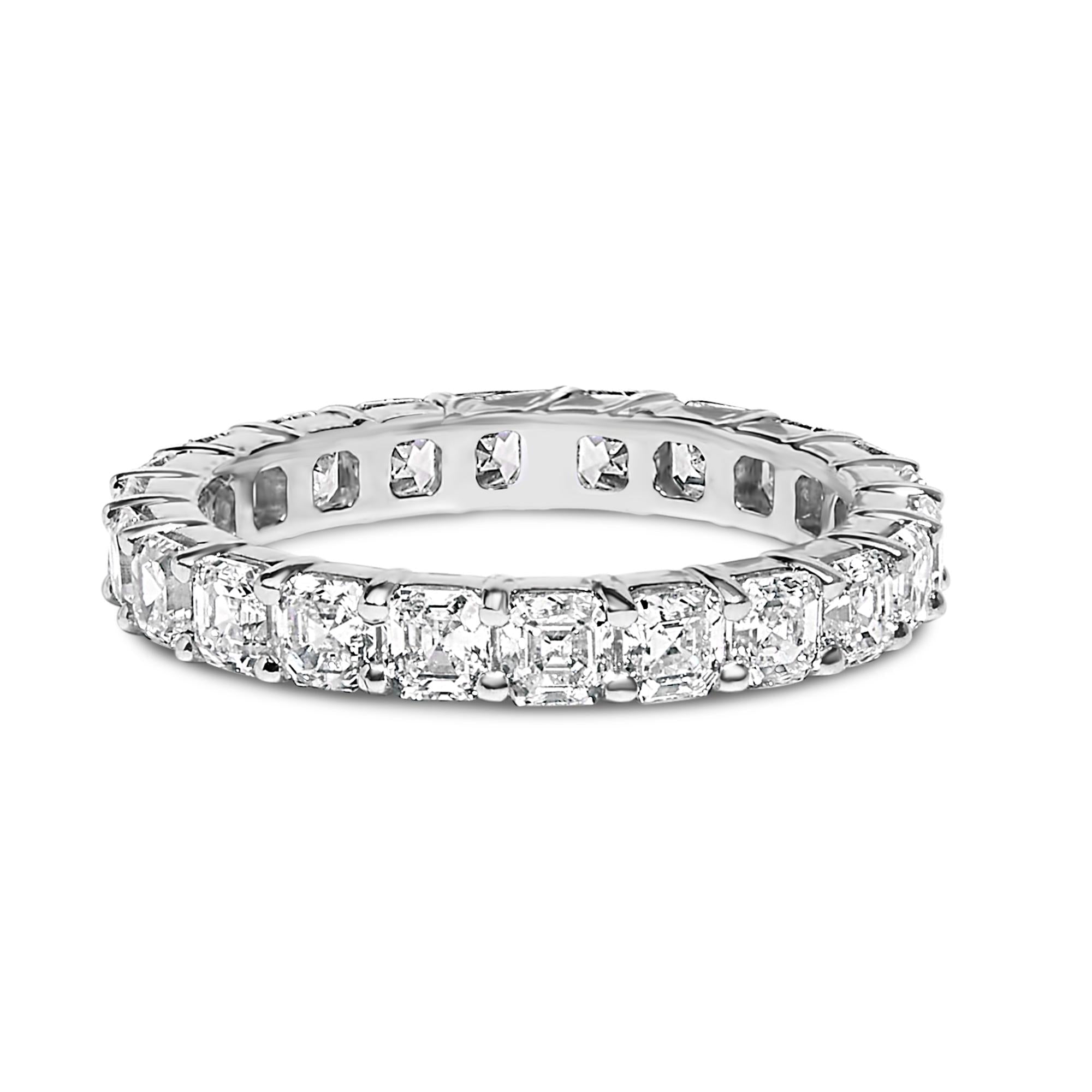 Silver eternity band with square-cut clear gemstones encircling the ring.