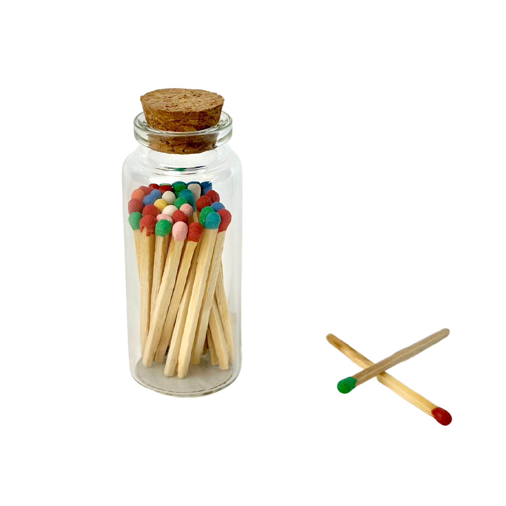 A corked jar with colorful matchsticks, two crossed outside with red and green tips.