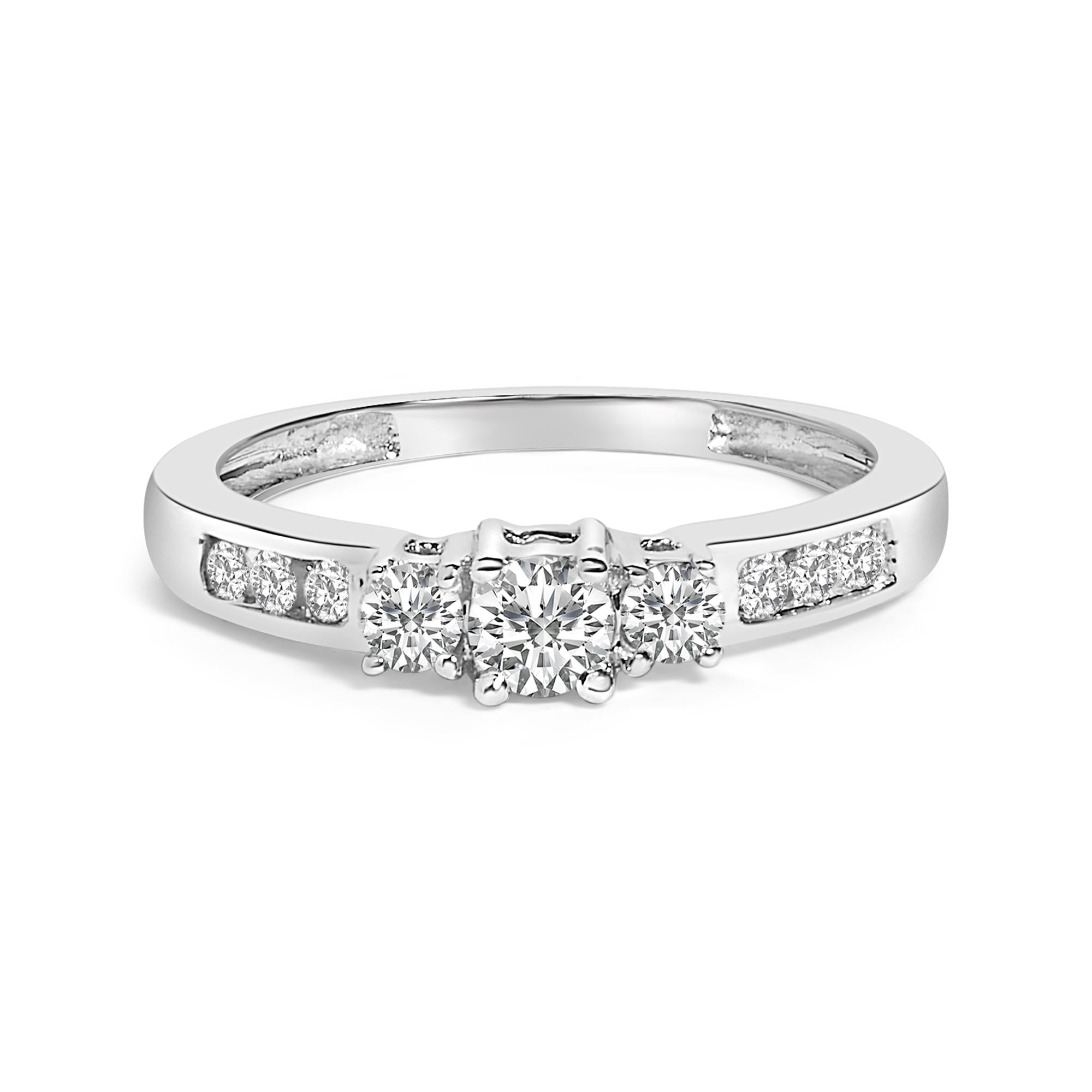 Silver ring with three round center diamonds and additional smaller diamonds set in the band.