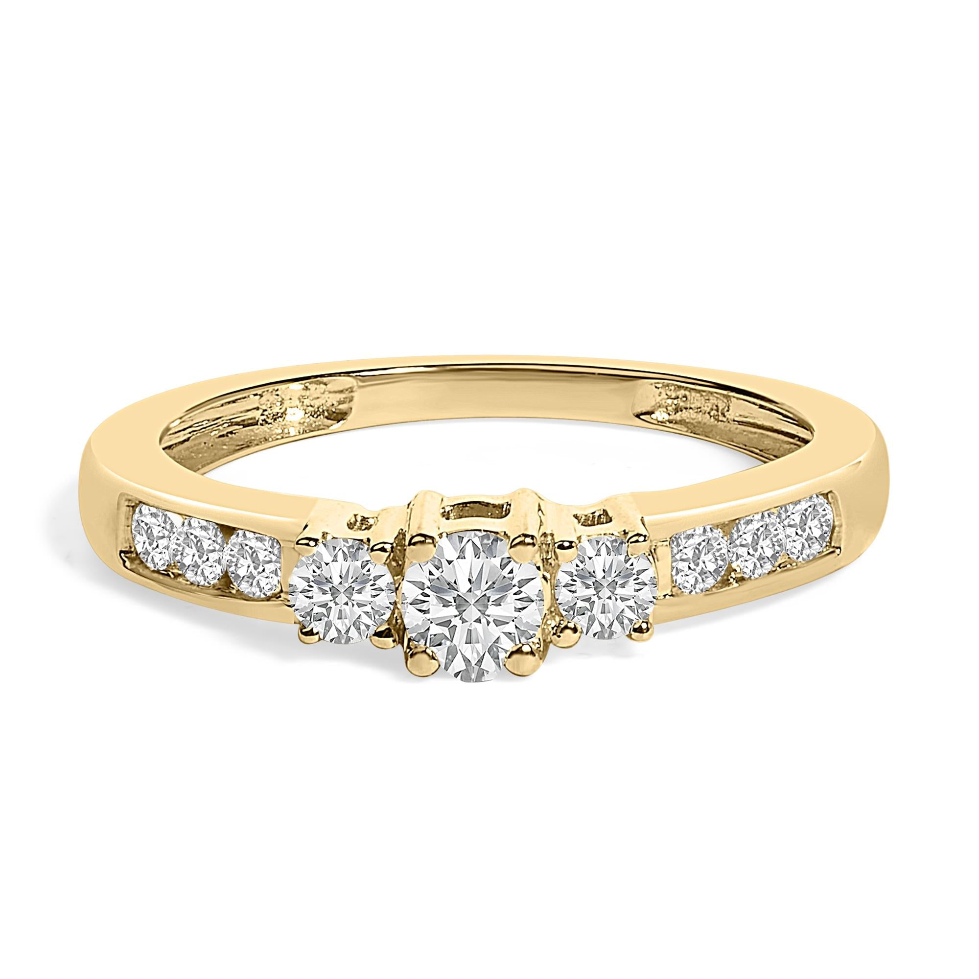 Gold ring with three larger diamonds in the center and smaller diamonds on the band.