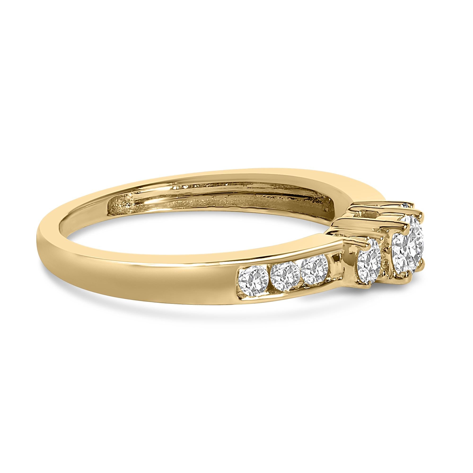 Gold ring with a row of small diamonds on the band and three larger diamonds on top.