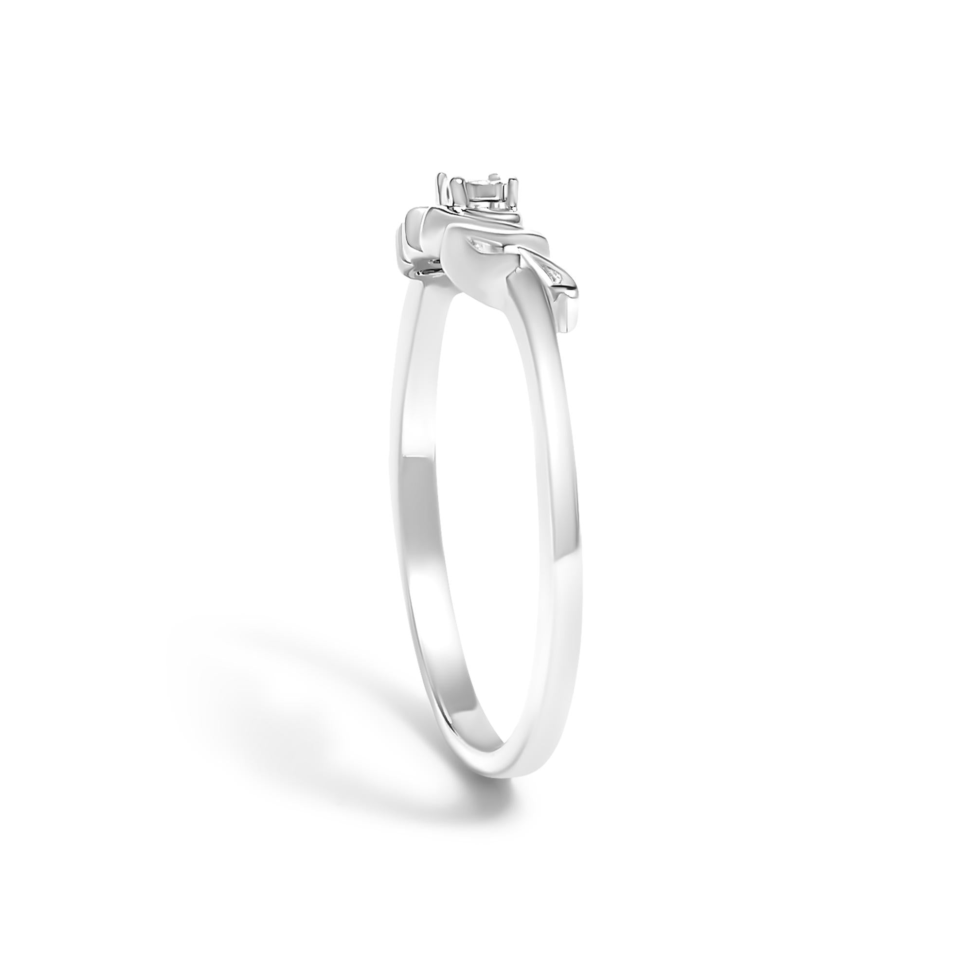 Silver engagement ring with a solitaire setting and a simple, polished band on a white background.