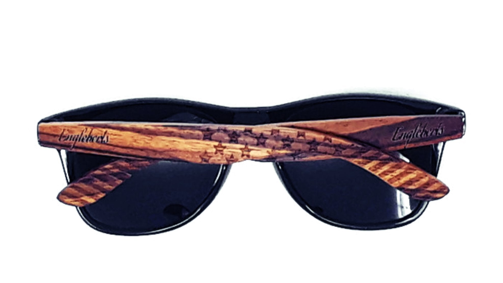 Sunglasses with dark lenses and wood-textured arms featuring engraved text on the side.