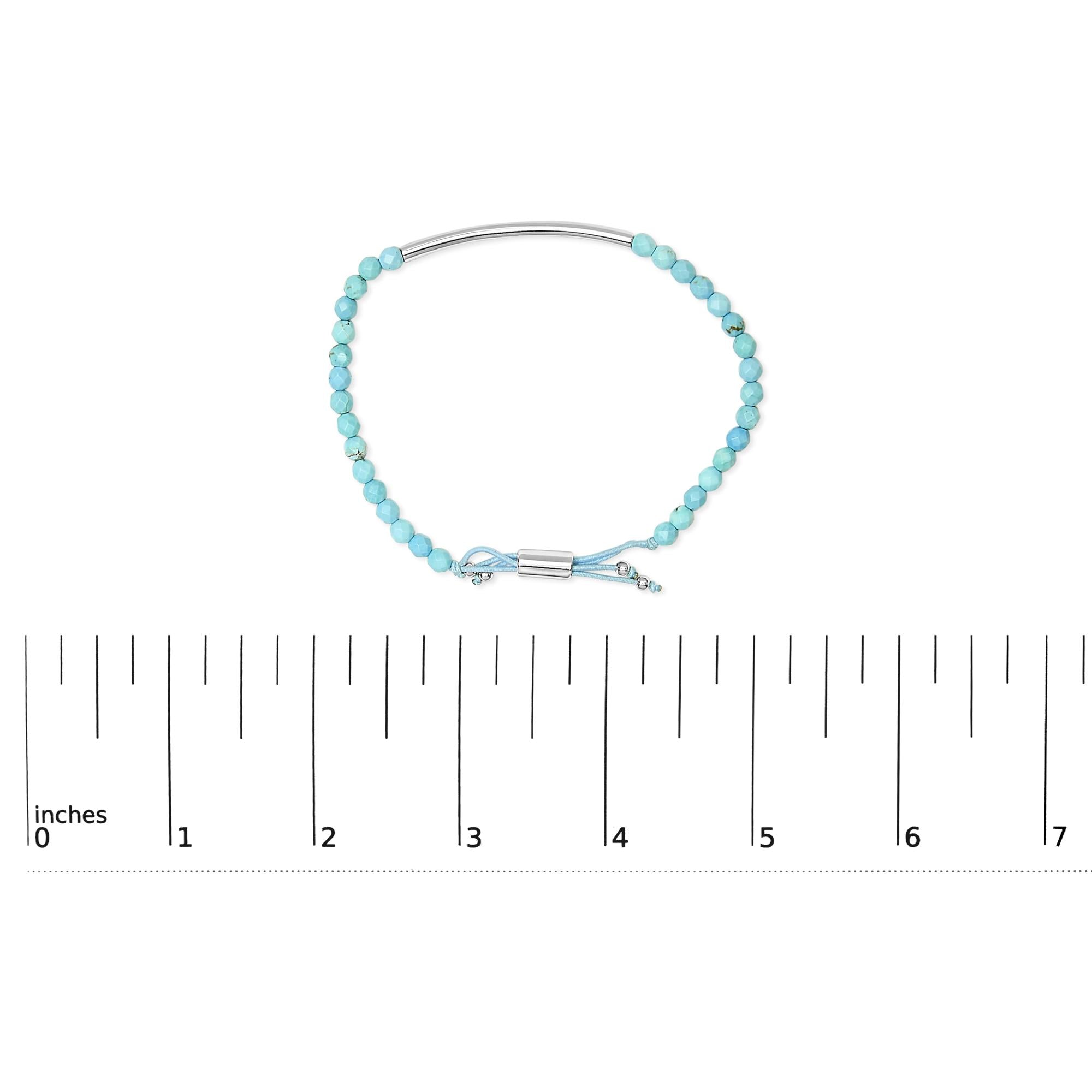 Turquoise bead bracelet with silver accents, clasp, and a ruler showing size in inches.