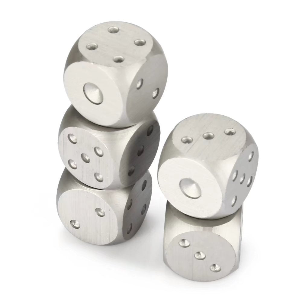 Four stainless steel dice stacked, showing smooth metallic finish and engraved dots.