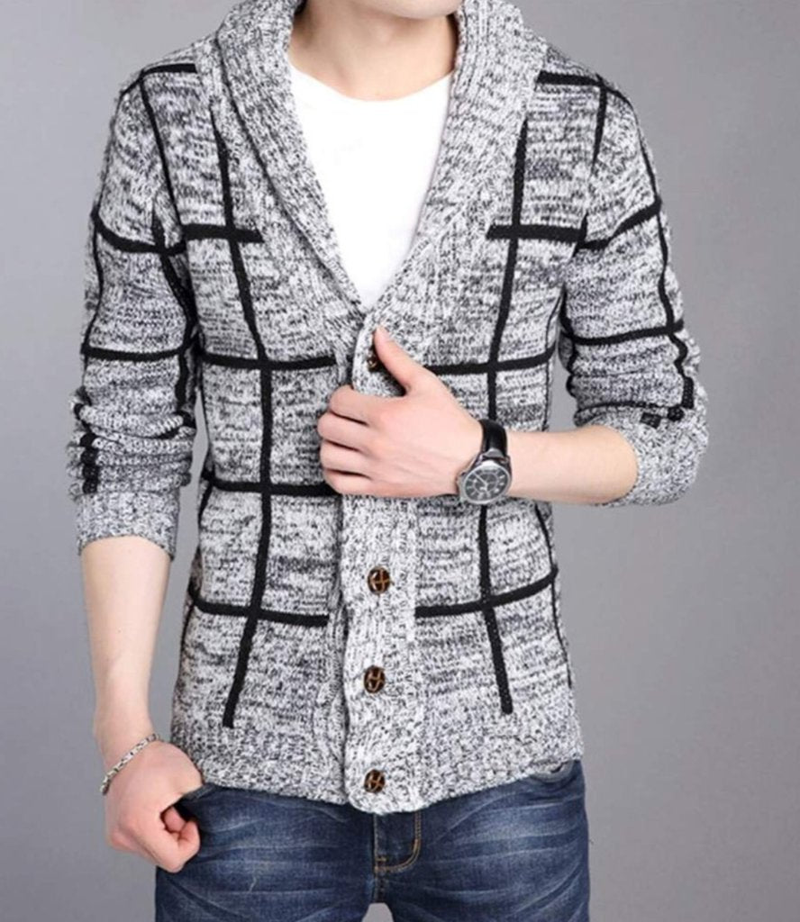 Person wearing a gray checkered cardigan with brown buttons, white shirt, and blue jeans.
