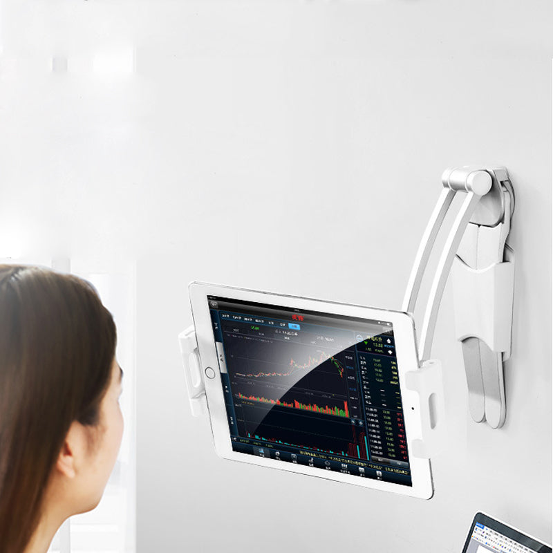 Wall-mounted tablet displaying charts, viewed by a person. White stand, light background.