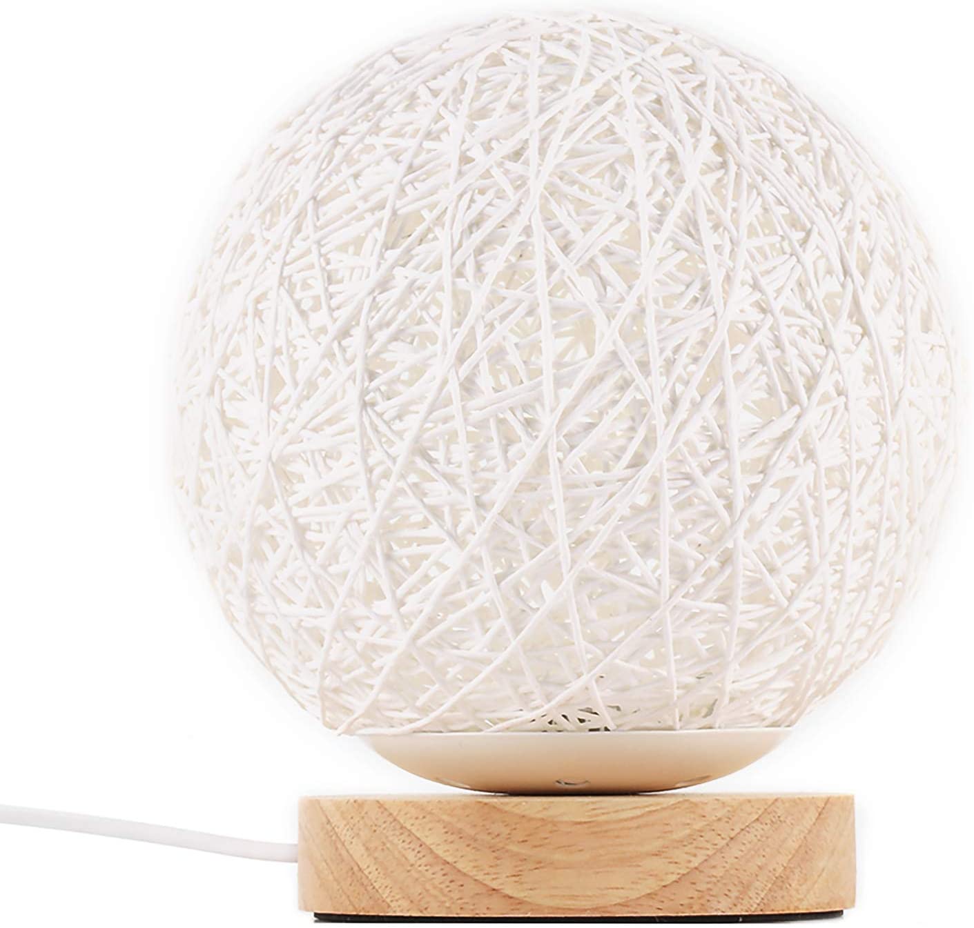 White string orb lamp on a wooden base with intricate crisscross design.