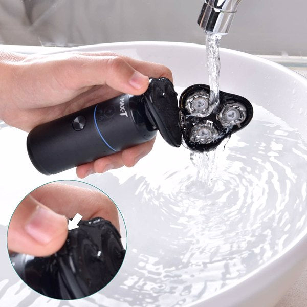 Hand rinsing a black electric shaver under running water over a white basin. Close-up inset included.