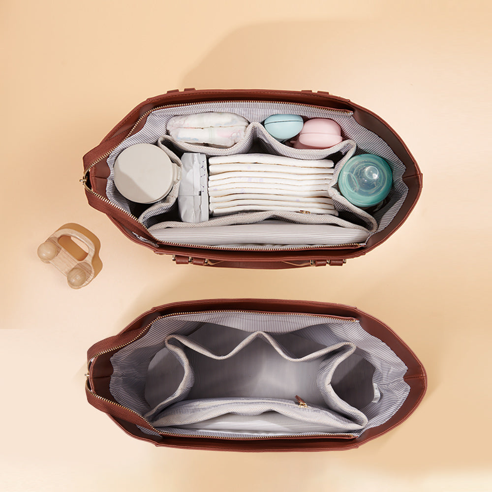 Two brown bags open, showing organized compartments with baby items like bottles and diapers.