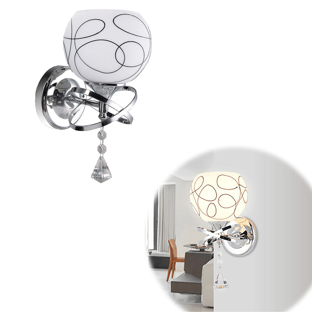 Modern wall lamp with swirling black lines, chrome details, and a hanging crystal pendant.