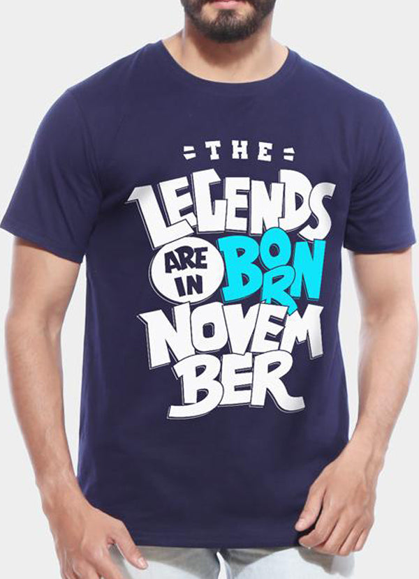 Man in a navy T-shirt with bold white and blue text saying "The Legends Are Born in November."