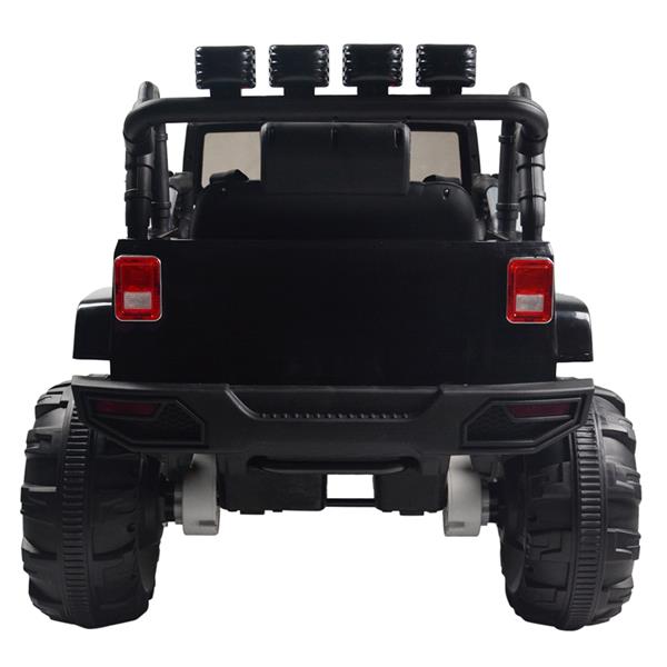 Black toy truck rear view with large wheels, roll bar, red taillights, and four top lights.