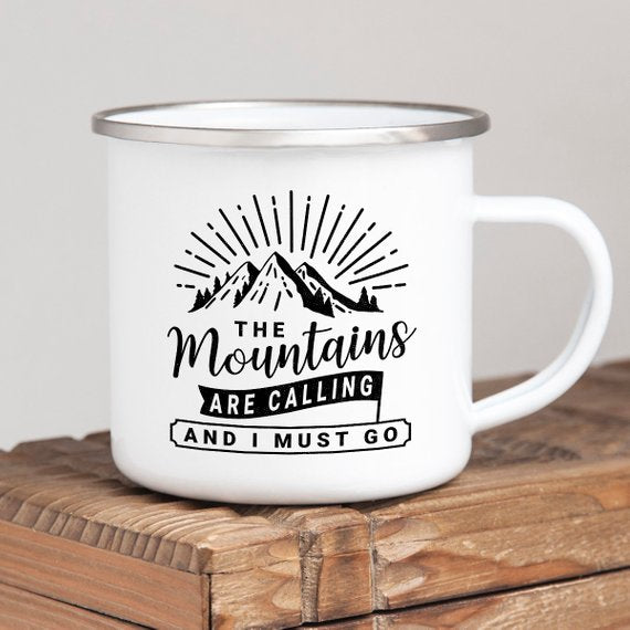 White enamel mug with mountain graphic and text: "The mountains are calling and I must go."
