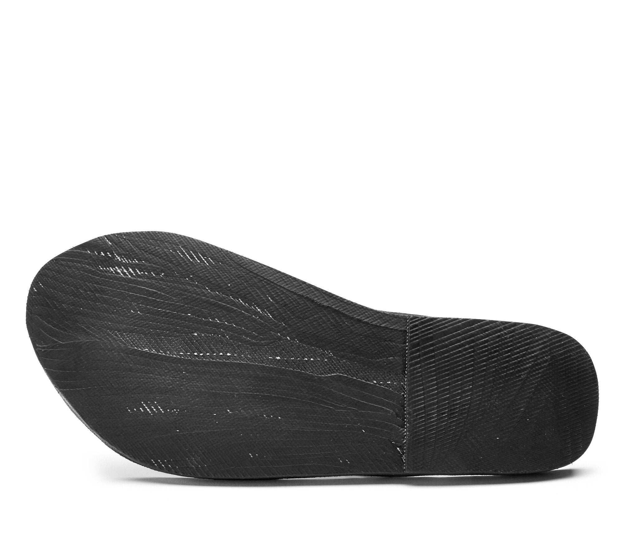 Black textured shoe sole with subtle white lines, showing a curved heel and tapered toe.
