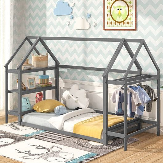 Gray house-shaped bed with shelves, soft bedding, and clothing rack. Chevron wall, cloud, and owl decor.