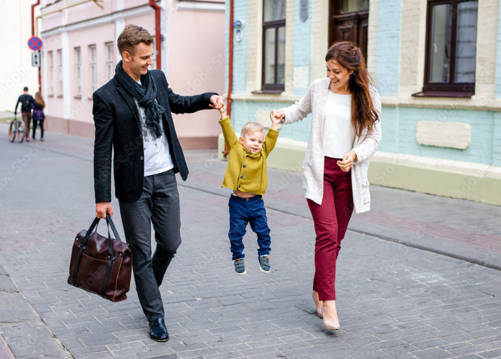 family walking down street with boy