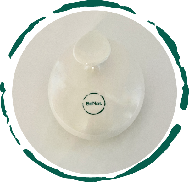 Minimalist white bottle with a circular green logo reading "BeNat," on a white background.