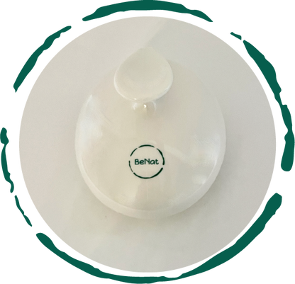 Minimalist white bottle with a circular green logo reading "BeNat," on a white background.