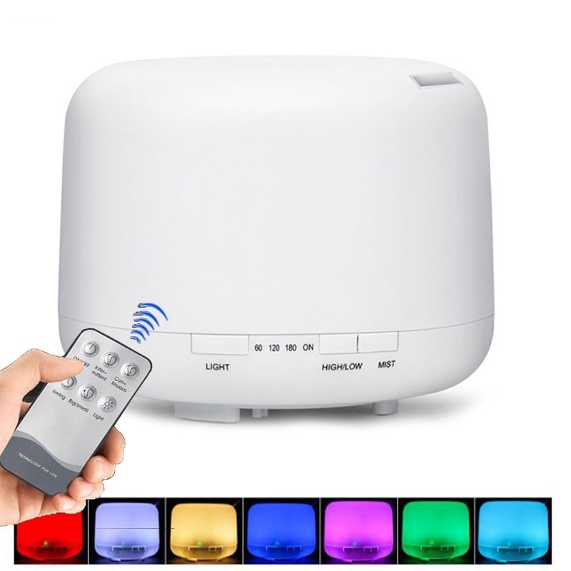 White diffuser with buttons for light and mist settings, shown with remote and multicolor lights.
