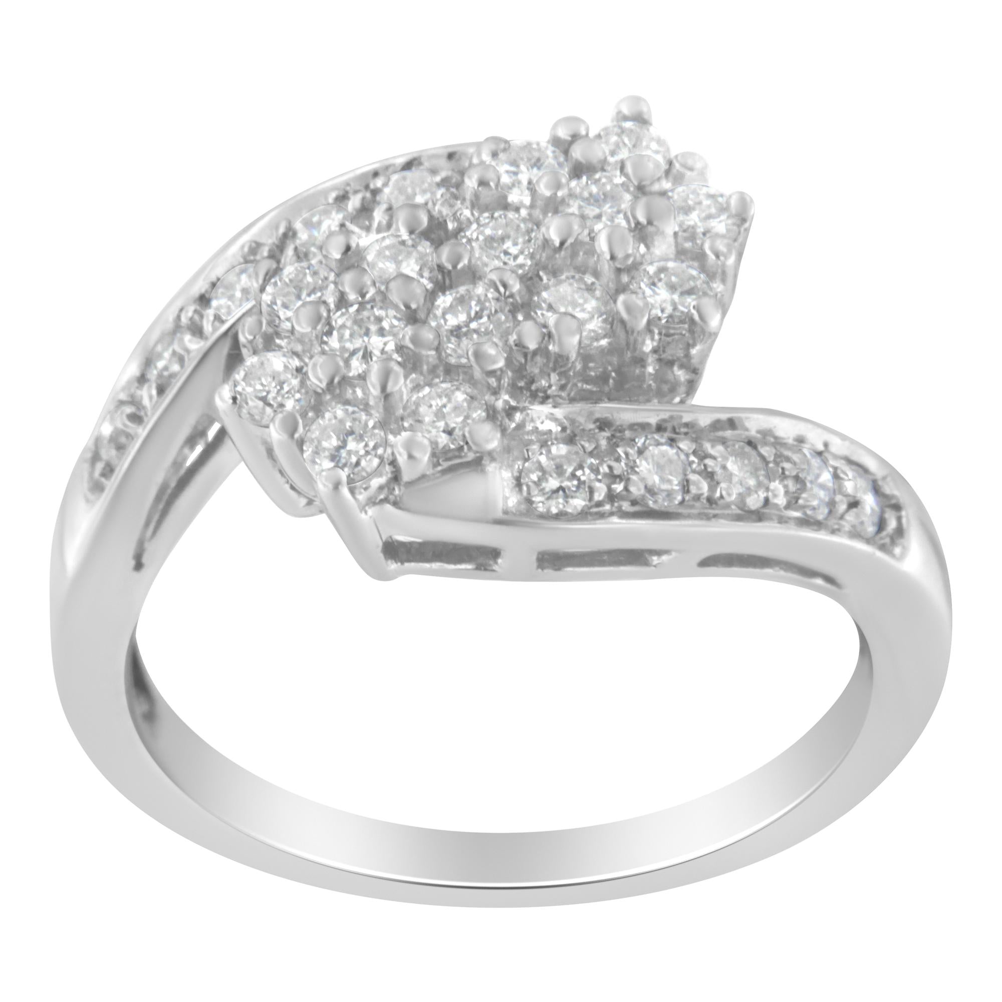 Silver ring with a curved band, adorned with clusters of sparkling white gemstones.