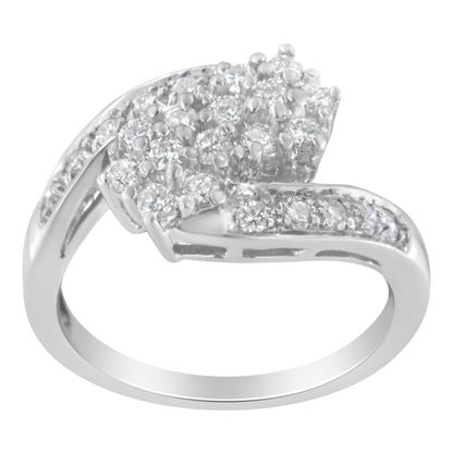 Silver ring with a curved band, adorned with clusters of sparkling white gemstones.
