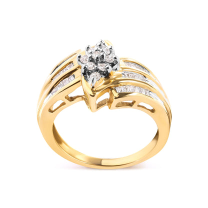 Gold ring with split band, featuring a cluster of round and rectangular diamonds on top.