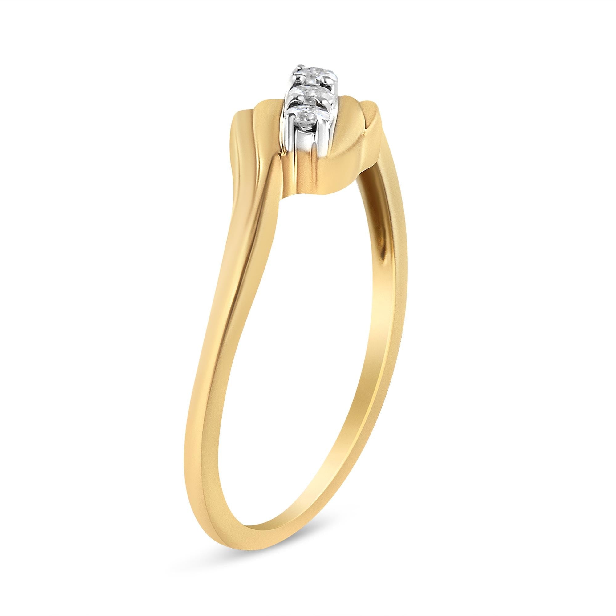 Gold ring with a slender band, featuring three small diamonds in a white setting on top.