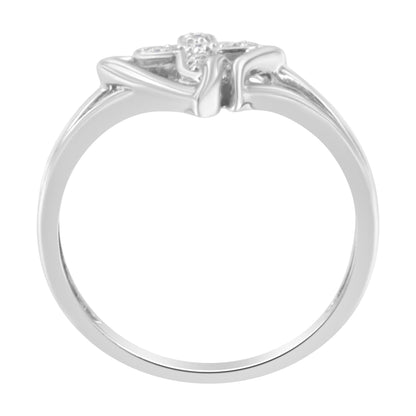 Silver ring with a floral design on top, featuring intricate details and a glossy finish.