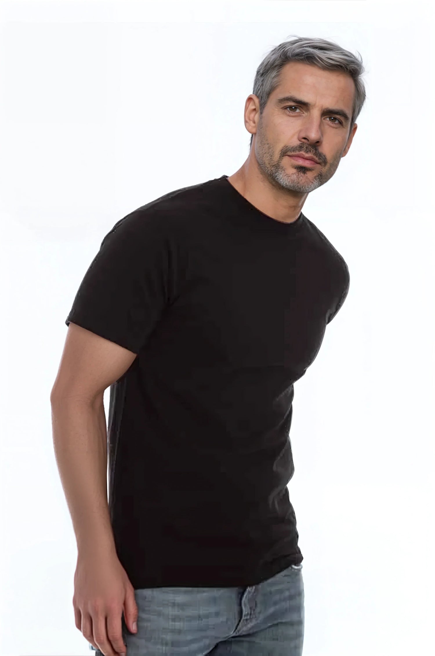 Man with gray hair wearing a black t-shirt and jeans against a white background.