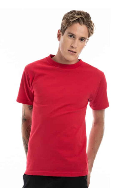 Man in a red t-shirt with short sleeves, light hair, and tattoos on his arms, standing against white.