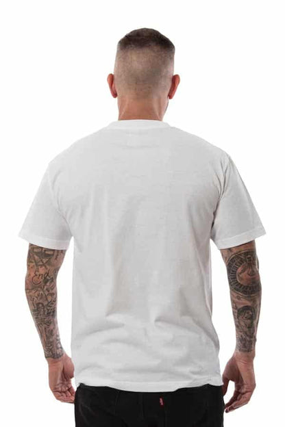 Man from behind wearing a white t-shirt and black pants, tattoos on both arms, short hair.