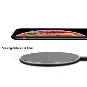 Smartphone above black wireless charging pad with text: "Sensing distance < 8mm."