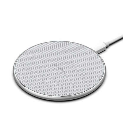 A round, silver-toned wireless charging pad with a textured grid surface and a connecting cable.