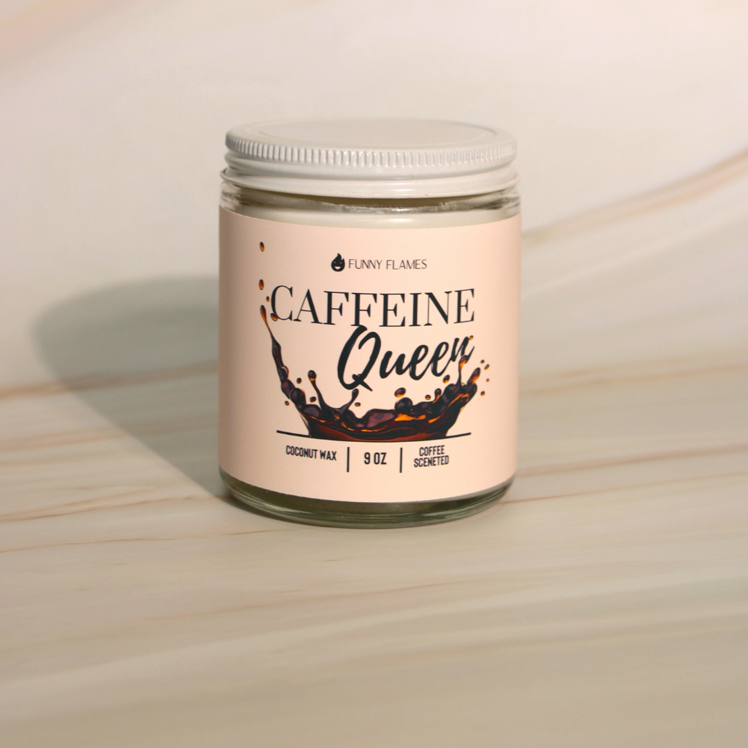Beige jar candle labeled "Caffeine Queen," 9 oz, on a light marbled surface.