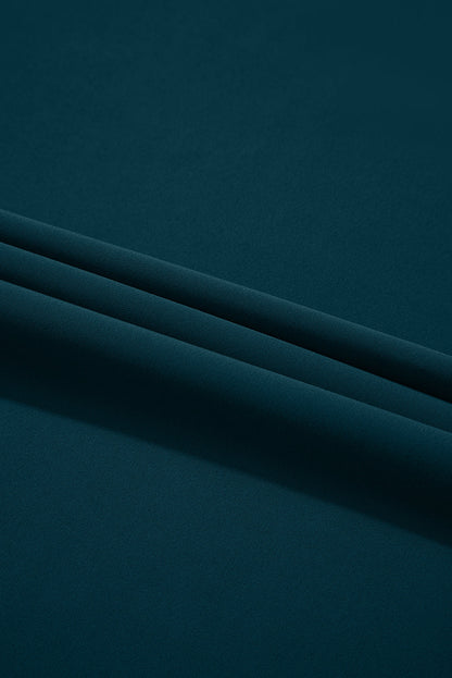 Dark teal fabric, smooth texture, with two neat horizontal folds creating subtle shadows.