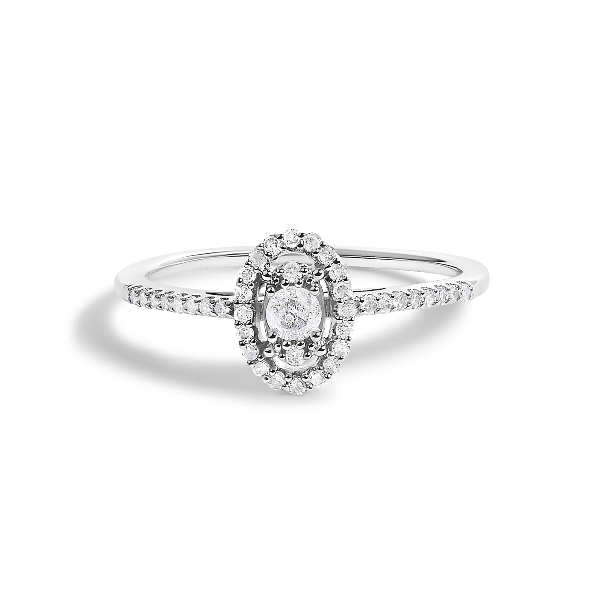 Silver ring with an oval diamond cluster setting and a band adorned with small diamonds.